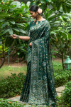 Dark green color tussar silk saree with zari woven border