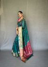 Rama green color organza silk saree with zari weaving work