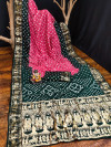 Baby pink and bottle green color hand bandhej silk saree with zari weaving work