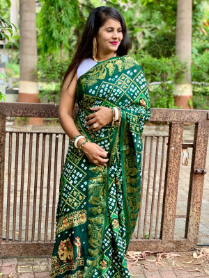 Green color pure hand bandhej silk saree with zari weaving work