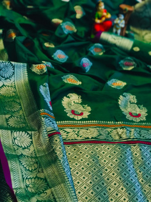 Green color soft banarasin silk saree with silver zari weaving work