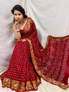 Red color bandhani silk saree with khadi printed work