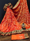 Orange color pure hand bandhej silk saree with printed work