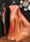 Orange color raw silk saree with woven design