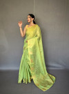 Parrot green color tissue silk saree with zari weaving work