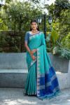 Rama green color tussar silk saree with zari weaving temple border