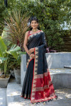 Black color tussar silk saree with zari weaving temple border