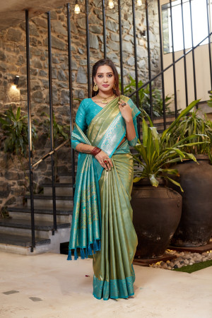 Soft flowy green color tissue silk saree with contrast woven border & blouse