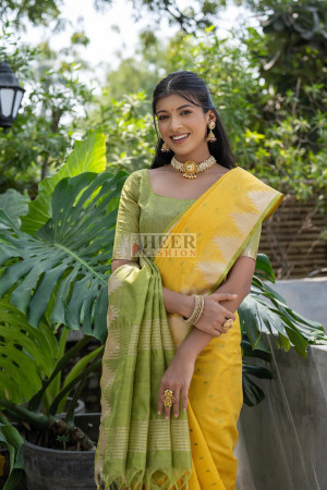 Yellow color tussar silk saree with zari weaving temple border