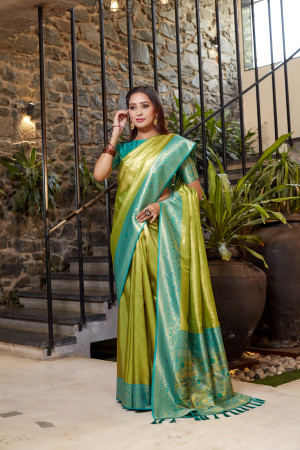 Soft flowy mahendi green color tissue silk saree with contrast woven border & blouse