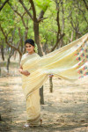 Yellow color pure linen saree with zari woven border and pallu