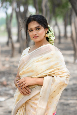 Cream color pure linen saree with zari woven border and pallu