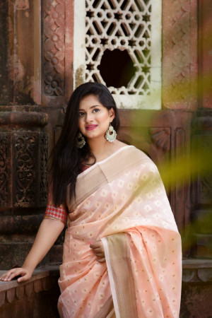Peach color pure linen saree with zari woven border and pallu