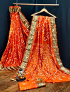 Orange color pure hand bandhej bandhani saree with zari weaving work