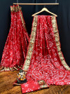 Red color pure hand bandhej bandhani saree with zari weaving work