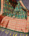Dark green color patola silk saree with woven design