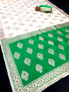 Off white and green color banarasi silk saree with zari weaving work