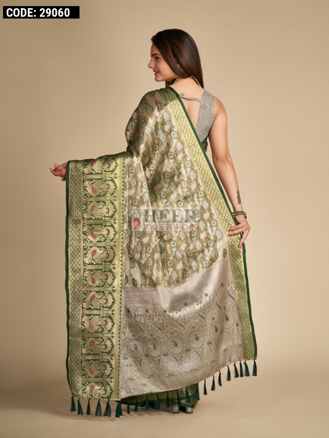 Bottle green color tissue silk saree with woven design