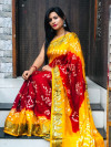 Red and yellow color bandhani saree with hand bandhej print