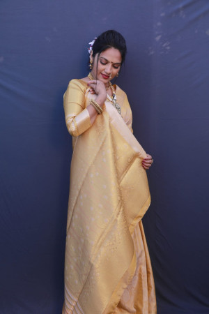 Yellow color muslin silk saree with zari weaving work