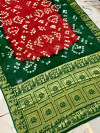 Red and green color bandhej silk saree with zari weaving work