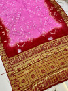 Baby pink and red color bandhej silk saree with zari weaving work
