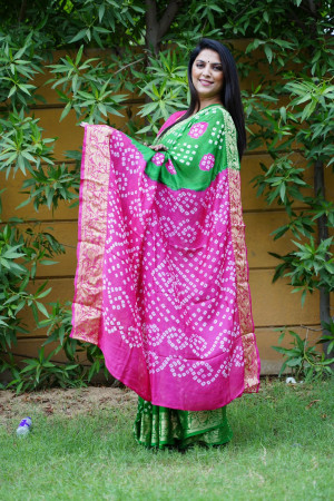 Green color hand bandhej silk saree with bandhani printed work