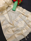 Cream and green color tissue silk saree with zari weaving temple border