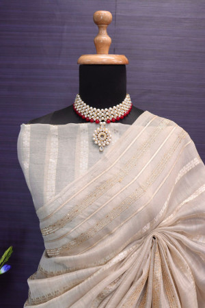 Beige color soft tussar silk saree with zari weaving work