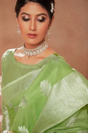 Pista green color soft linen silk saree with zari weaving work
