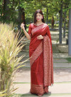 Red color raw silk saree with woven design