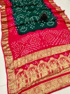 Pink and dark green color bandhej silk saree with zari weaving work