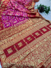Rani pink and red hand bandhej silk saree with zari weaving work