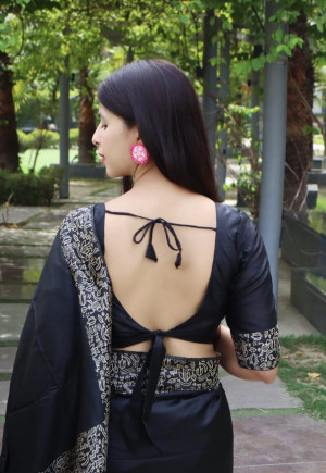 Black color raw silk saree with woven design