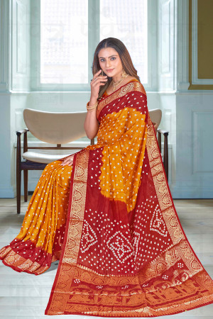 Maroon and yellow color bandhej silk saree with zari weaving work