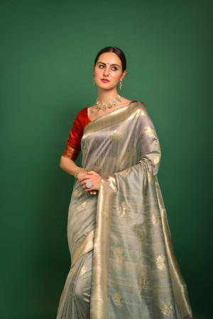 Beige color tussar silk saree with woven design