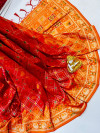Red and orange color patola silk saree with golden  zari weaving work