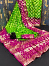 Parrot green and rani pink color soft art silk saree with zari weaving work
