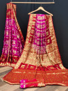 Rani pink and red color bandhej silk saree with zari weaving work