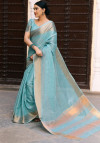 Sky blue color tussar silk saree with zari woven border