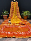 Mustard yellow and orange color pure hand bandhej silk saree with zari weaving work