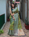 Mahendi green color organza silk saree with woven design