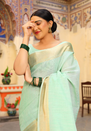 Pista green color tussar silk saree with zari woven border