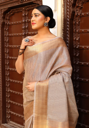 Beige color tussar silk saree with zari woven border