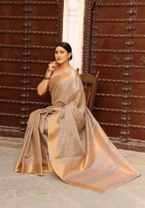 Beige color tussar silk saree with zari woven border