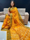 Orange color bandhani saree with hand bandhej work